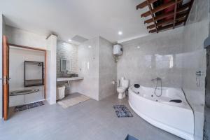 a large bathroom with a tub and a toilet at Villa Orenda 3-bedroom&3-bathroom in Sanur +37 photos