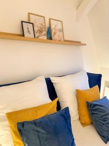 een kamer met witte en blauwe kussens op een bank bij soulscape Apartments Zwickau kompakter LOFT-Wohnraum mit Lift direkt in die Wohnung, modern, zentrumsnah, gratis WIFI in Zwickau
