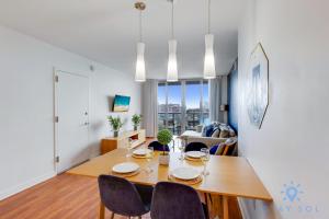 a dining room and living room with a table and chairs at Infinite View Balcony - Amazing Pool - Gym in Hallandale Beach