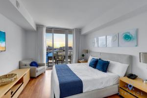 a bedroom with a bed and a living room at Infinite View Balcony - Amazing Pool - Gym in Hallandale Beach