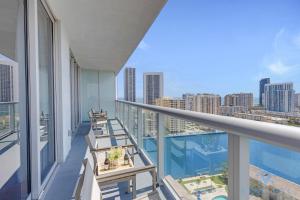a balcony with chairs and a view of the city at Infinite View Balcony - Amazing Pool - Gym in Hallandale Beach
