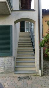 a set of stairs leading to a building with a door at La Casa Di Baba' in Alfiano Natta