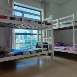 two bunk beds in a room with a window at Sea la Vie in Dubai