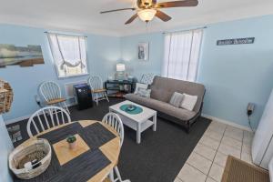 a living room with a couch and a table at Quarter Deck Cottage on Flagler Beach in Flagler Beach