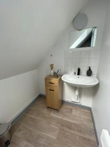 a white bathroom with a sink and a mirror at Le Touquet in Le Touquet-Paris-Plage +7 photos