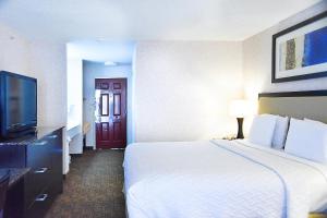 a hotel room with a large bed and a flat screen tv at Argo Inn and Suites in Idaho Springs