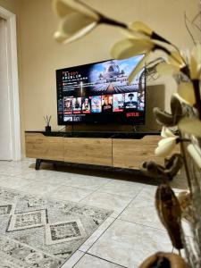 a large flat screen tv sitting in a living room at Cozy home in Nea Smirni in Athens