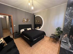 Supreme City Heart Apartment في أليكساندروبولي: غرفة نوم مع سرير وغرفة معيشة