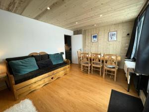 a living room with a couch and a table and chairs at Résidence Sefcotel - Studio pour 4 Personnes 201 in Tignes