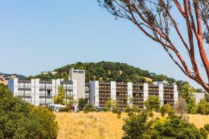 an apartment building on a hill with trees at Four Points by Sheraton San Rafael Marin County in San Rafael