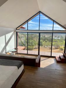 a bedroom with a large glass window and a bed at 7 Valles in Ensenada