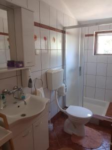 a bathroom with a toilet and a sink and a shower at Holiday Home Nada in Sali