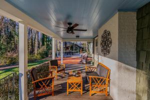 a porch with chairs and a ceiling fan at Artopia Retreat in Greensboro