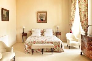 um quarto com uma cama, 2 cadeiras e uma cómoda em Chateau Sénailhac em Tresses