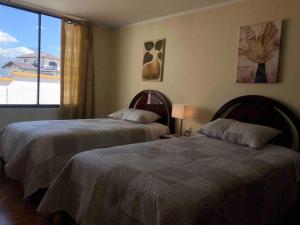 Ένα ή περισσότερα κρεβάτια σε δωμάτιο στο Apartamento Tranquilo y Espacioso cerca de Quito