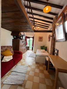 a living room with a red couch and a table at Alojamiento Casco Antiguo Salobeña in Salobreña