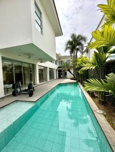 a swimming pool in front of a house at casa en samborondon in Guayaquil