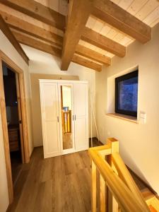 a living room with wooden ceilings and a tv at El Gallinero de Tiago in Lebena