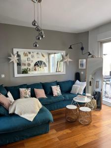 a living room with a blue couch and a table at Beautiful & Spacious 3BD Family Home w Terrace in Paris