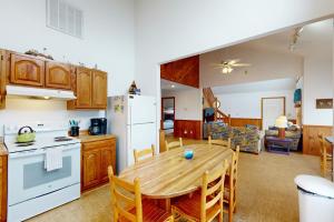 a kitchen and living room with a wooden table and chairs at Sunny Daze SO08 in Salvo