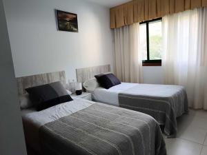 a hotel room with two beds and a window at Gran Paraíso Raxo in Raxó