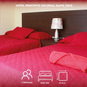 two beds with red comforters in a bedroom at PRINCIPITO SANTA CRUZ in Santa Cruz de la Sierra