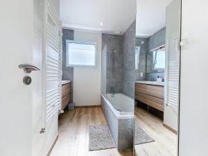 a bathroom with a tub and a sink at Le Ruffa in Bohars +43 photos