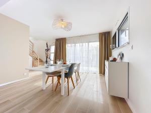 a kitchen and dining room with a white table and chairs at Le Ruffa in Bohars