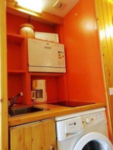 a small kitchen with a sink and a washing machine at Résidence Grand Arbois - Studio pour 4 Personnes 57 in Arc 1800