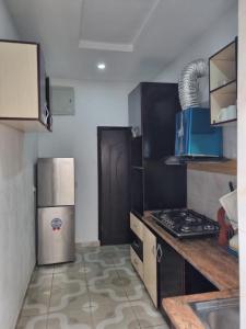 a kitchen with a refrigerator and a stove at Pentagon Court Phase 1 Apartment Ikota in Lagos