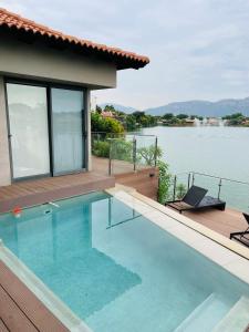 a swimming pool with a view of the water at Lulanipho Abode in Hartbeespoort