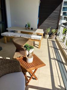 a patio with a table and chairs on a balcony at Modern, beautiful 1 bed with views -V&A Waterfront in Cape Town
