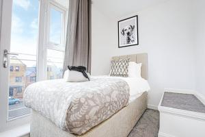 a bedroom with a large bed and a window at Alpha Properties 1 - Luxury One Bedroom within a Shared Four Bedroom House with Free Parking, Fast Wifi, SmartTV with Netflix in Milton Keynes