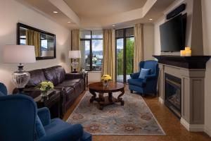 a living room with a couch and a fireplace at The Royal Kelowna - Bellstar Hotels & Resorts in Kelowna