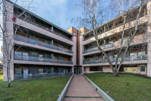 un edificio de apartamentos con una pasarela delante de él en La Casetta di Bubi, en Udine