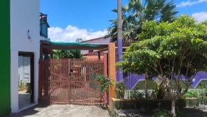 a gate to a house with a church at Pousada PETIT CHALET Canoa Quebrada in Canoa Quebrada