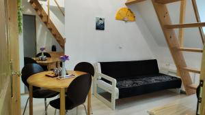 a small living room with a couch and a table at Homestay chez Lien proche RER B in Bures-sur-Yvette