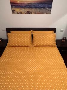 a bed with polka dot pillows in a bedroom at Coco Apartment in Bergamo