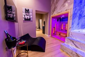 a room with a tub and a table with a bottle of wine at Maximum hub suite&spa in Palermo