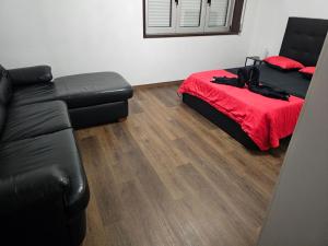 a living room with a bed and a couch at Reis Apartment in Rio Tinto