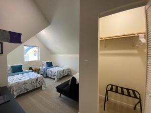 a small room with two beds and a window at Talkeetna Bush Pilot House in Talkeetna