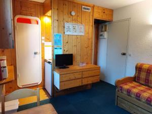 a room with a refrigerator and a tv on a wooden cabinet at Résidence Nova - Studio pour 2 personnes, au coeur de la station d'Arc 1800 dans le village des Villards MAE-2221 in Arc 1800