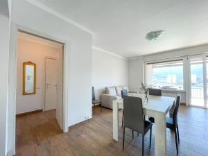 a white dining room with a table and chairs at CASA SOFIA in Sarnico +6 photos