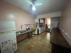 a kitchen with a sink and a refrigerator in it at LiveRio Hostel Ipanema in Rio de Janeiro