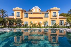 a villa with a swimming pool in front of a house at Ema Houses in Antalya