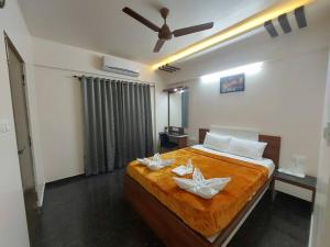 a bedroom with a bed with two white flowers on it at 11. 101@HSR Premium Fully Furnished 1BHK Flat in Bangalore
