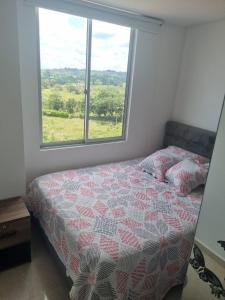a bedroom with a bed and a window at Apartamento Norte de Armenia in Armenia