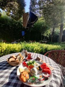 a picnic table with a plate of food on it at London Hotel in Oludeniz
