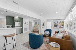 a living room with a couch and chairs at 29 Palms in Anna Maria