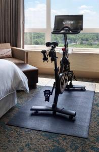 a room with a exercise bike on a rug at The Westin Chicago North Shore in Wheeling